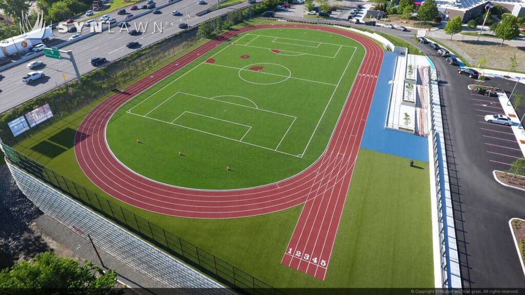 Artificial grass track turf